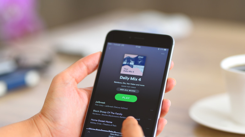 person using Spotify app