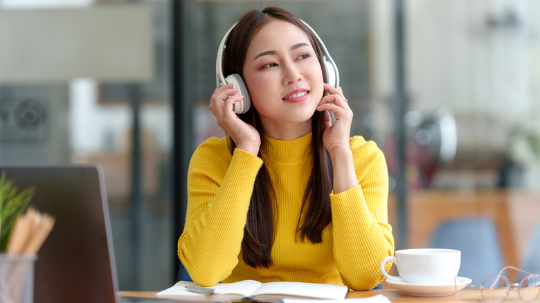 Woman listening to music at a desk