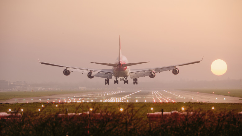 Boeing 747 landing at sunset