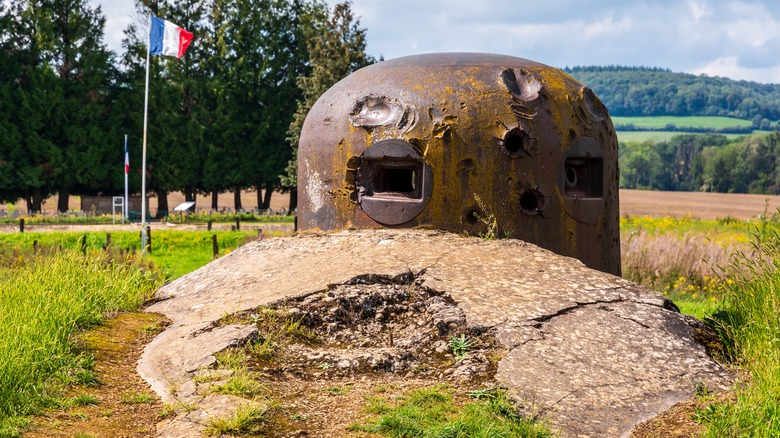 Domed shaped bunker from WWII with French flag in the background