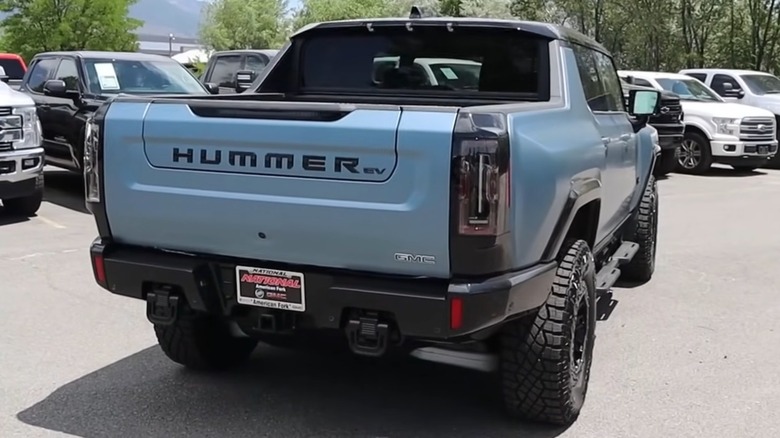 A light blue Hummer EV 3X Omega edition from the back.