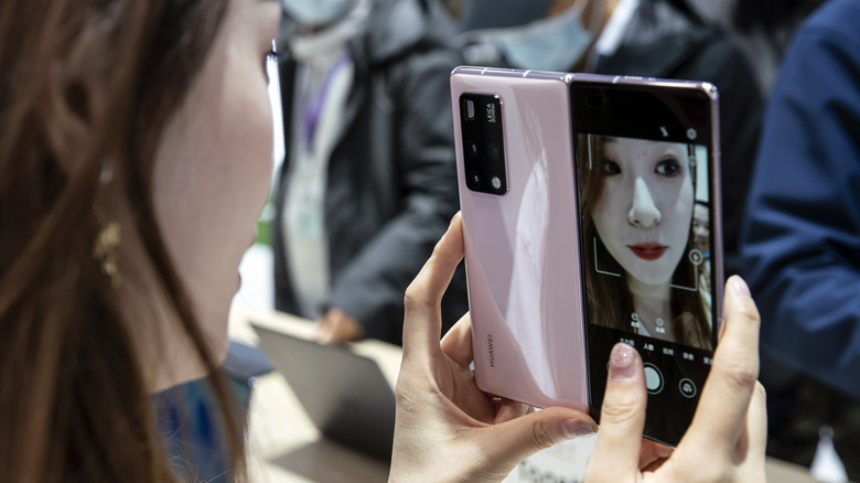 Woman using a Huawei foldable phone