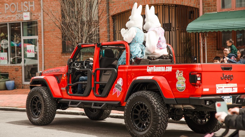 Pair of Easter bunnies riding in a red Jeep at the Easter Parade in Philadelphia, Pennsylvania.