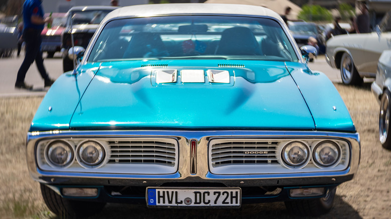 Blue Dodge Super Bee parked in grass