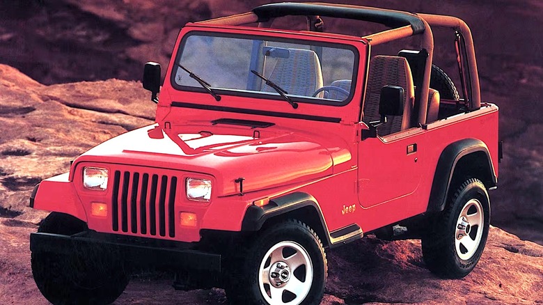 Jeep Wrangler with square headlights parked by cliff