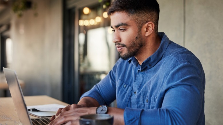 A person doing research on a laptop