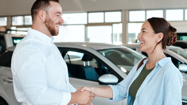 Shaking hands at a dealership