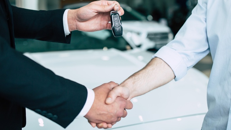 Shaking hands at a dealership