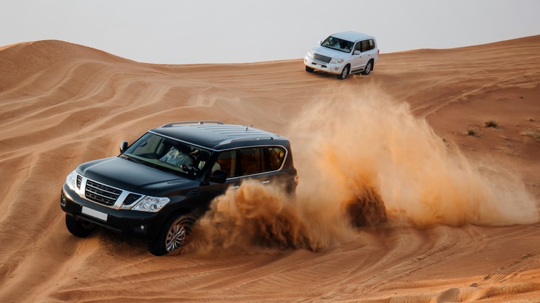 Two SUVs racing in desert