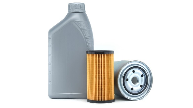 an image depicting a jug of oil, a canister or cartridge style oil filter, and a screw on oil filter