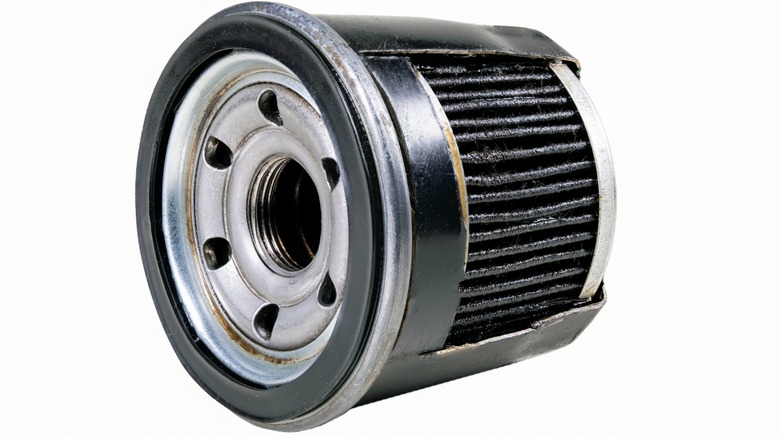 an engine oil filter with the side cut off to show the filter material inside