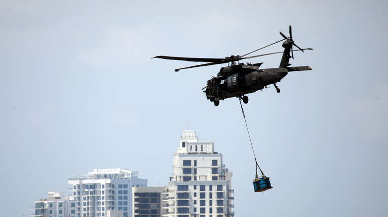 Black Hawk helicopter carrying a load