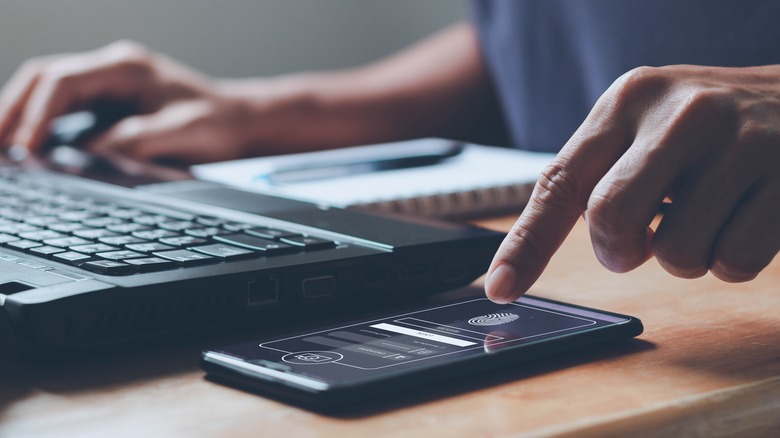 Man using fingerprint scan on phone