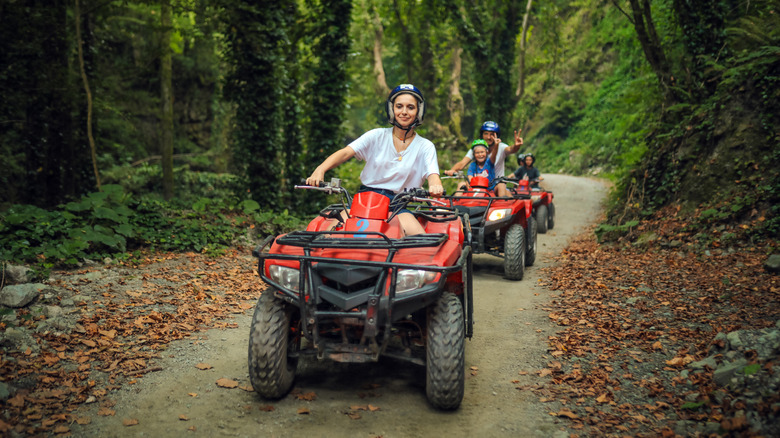 A family riding on ATVs