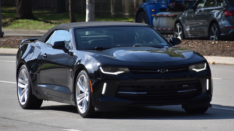 2023 black Chevy Camaro driving street