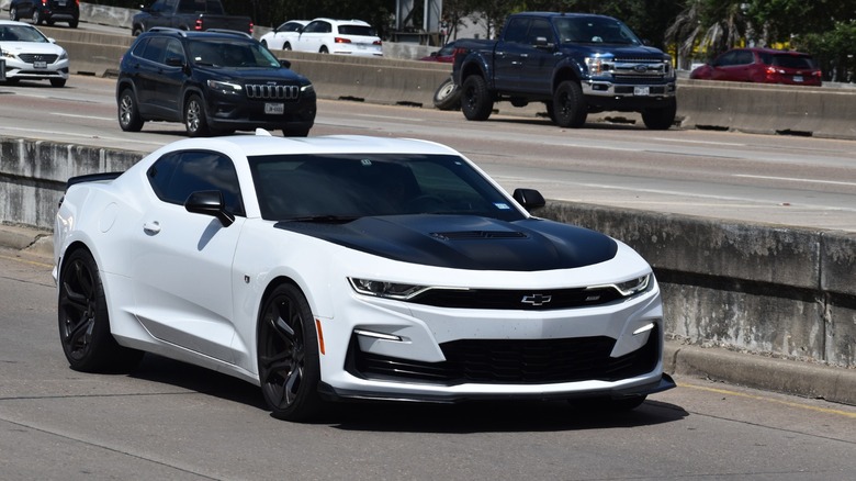 White 2023 Camaro driving on freeway