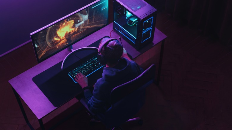 gamer at game station with large monitor