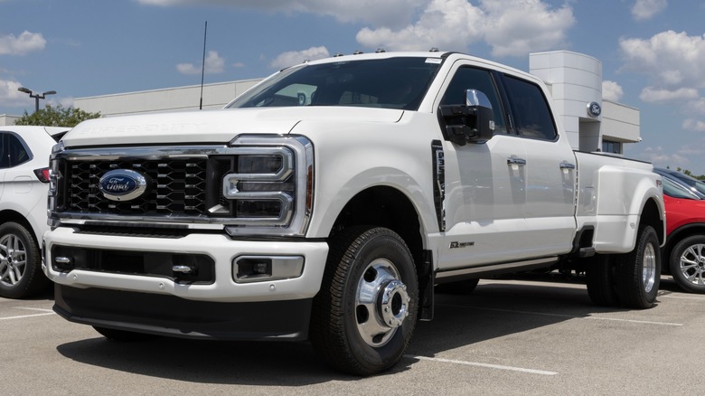 White Ford Super Duty pickup parked in lot