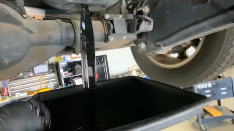 Draining oil from a 6.7L Cummins diesel engine.