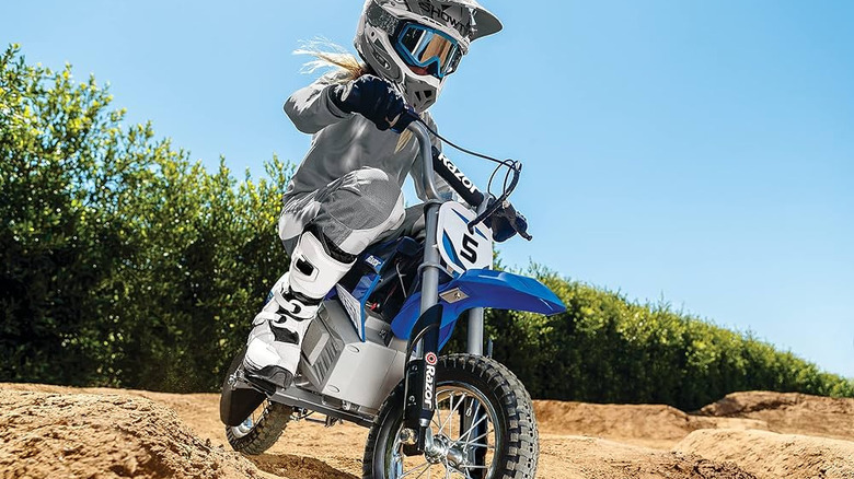 Kid riding blue bike on dirt