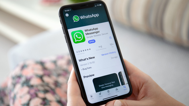 Woman using WhatsApp on iPhone