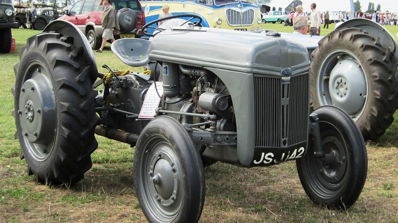 A black Ford Ferguson 9N tractor parked on grass