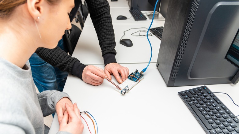 woman getting taught about Arduino