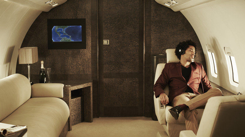 Man in a suit relaxing on a luxury private plane