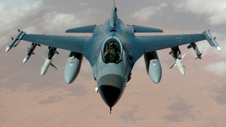 Polish F-16 Fighting Falcon flying towards camera over desert landscape