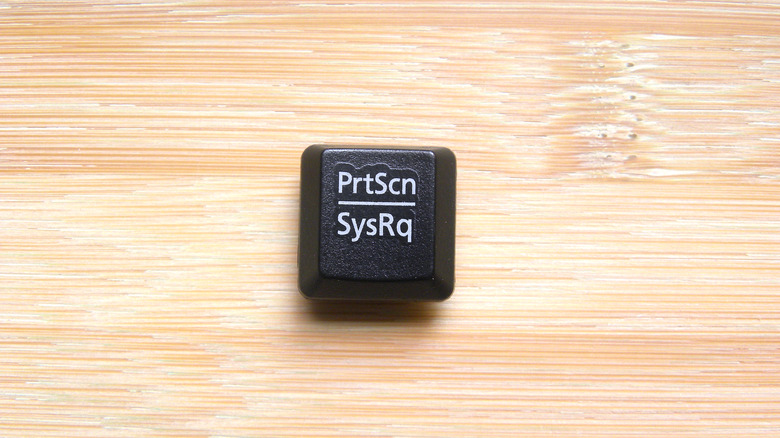 Black color Print screen key of computer keyboard on a wooden surface