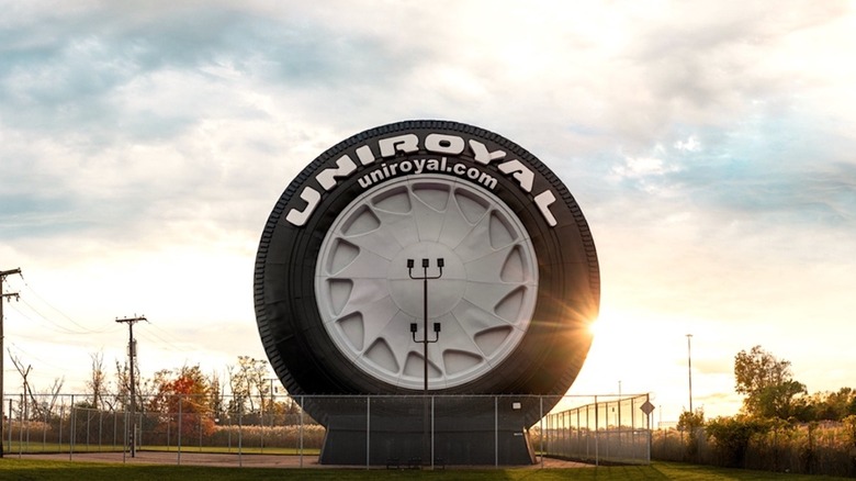 Giant Uniroyal Tires advertisement behind fence