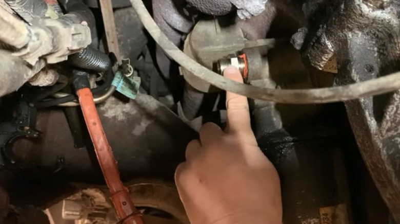 Putting a finger on the 7.3L Power Stroke block heater.