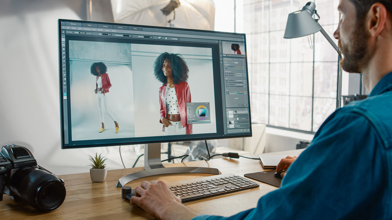 man editing photos on a desktop