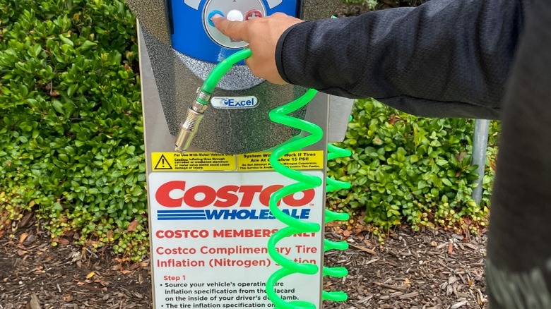 A person using a Costco nitrogen tire inflator