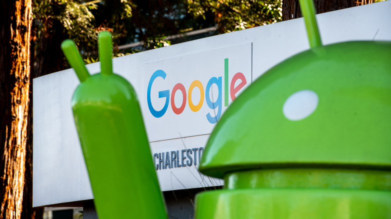 Google logo behind android statue