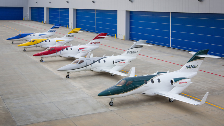 Five HondaJets parked in front of hangers