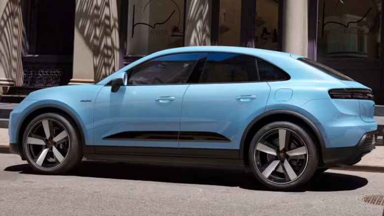 A powder blue Porsche Macan Electric, parked on a street