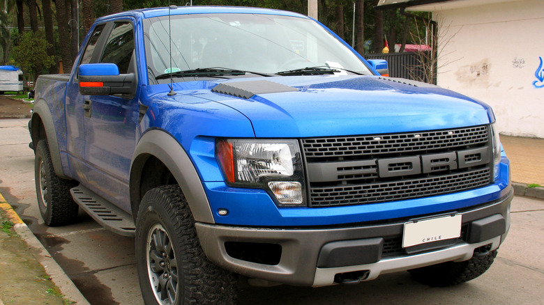 2011 Ford SVT Raptor parked next to building