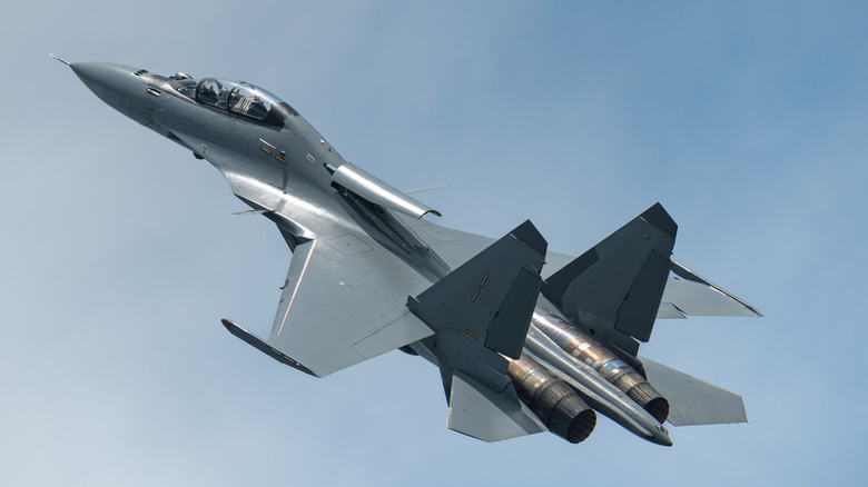 Su-30 flying over cloudy skies