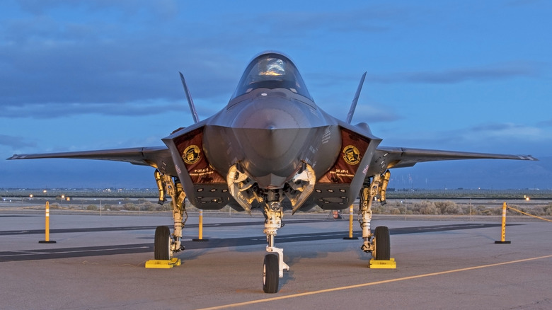 An F-35 Lightning on the runway at sunrise.