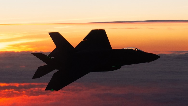 A U.S. Air Force F-35 flying at sunset.