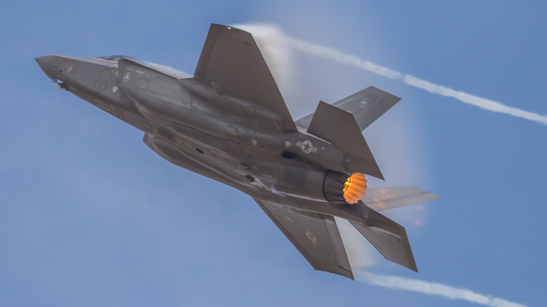 An F-35 Lightning II jet fighter flying into the sky.