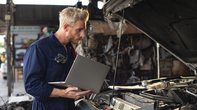 Mechanic Looking At Engine