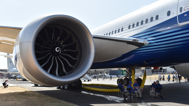 Staff sit in the shade under a Boeing 777X