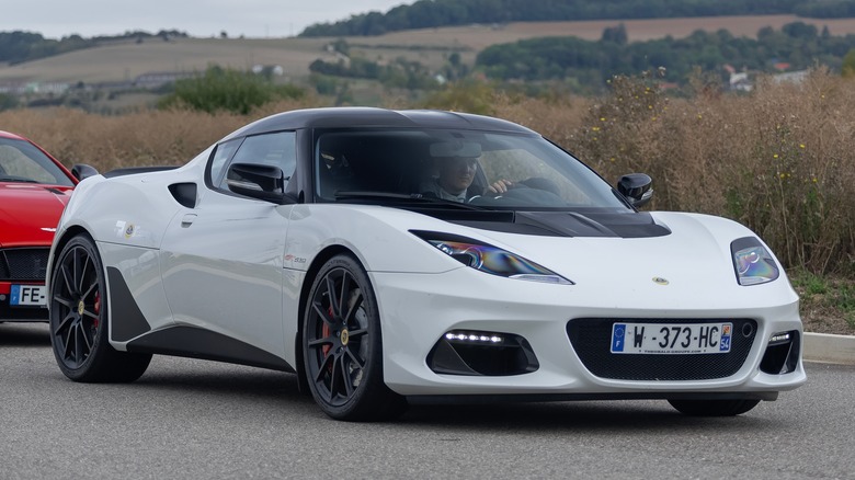 Man driving white Lotus Evora