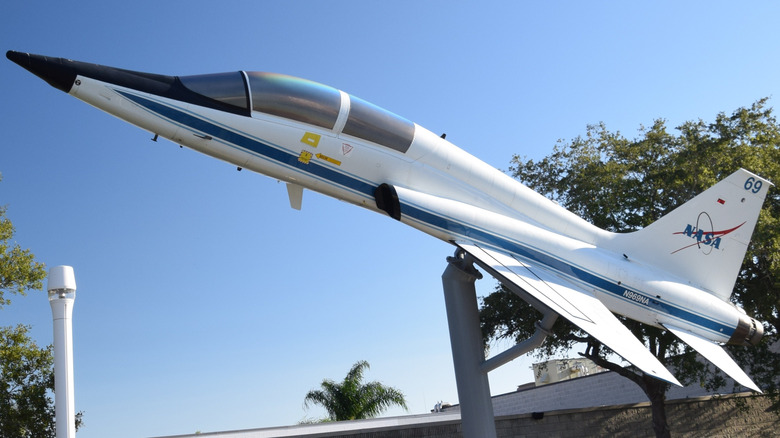 A Northrop T-38 Talon twin engine high altitude supersonic jet trainer on display for NASA pointed toward the sky