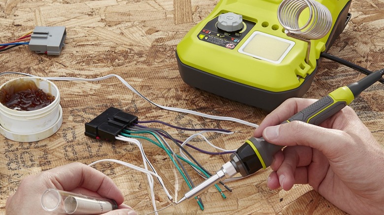 Person soldering wires together