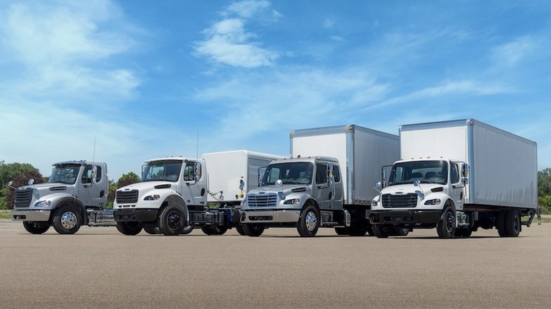 Four Freightliner Plus models parked