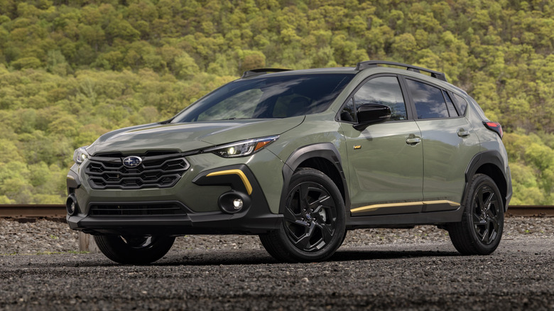 Dark green 2024 Subaru Crosstrek Sport parked on dirt