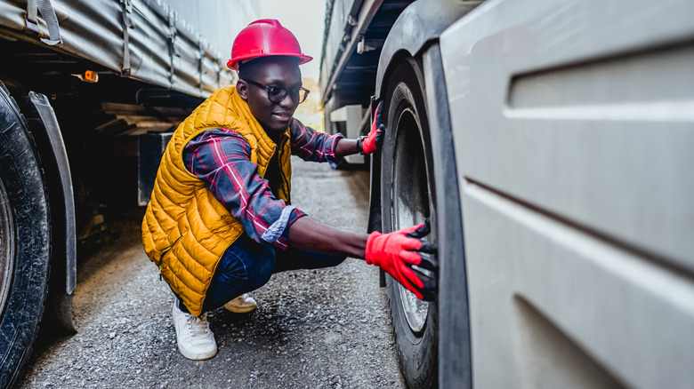 Inspector checking the truck tires